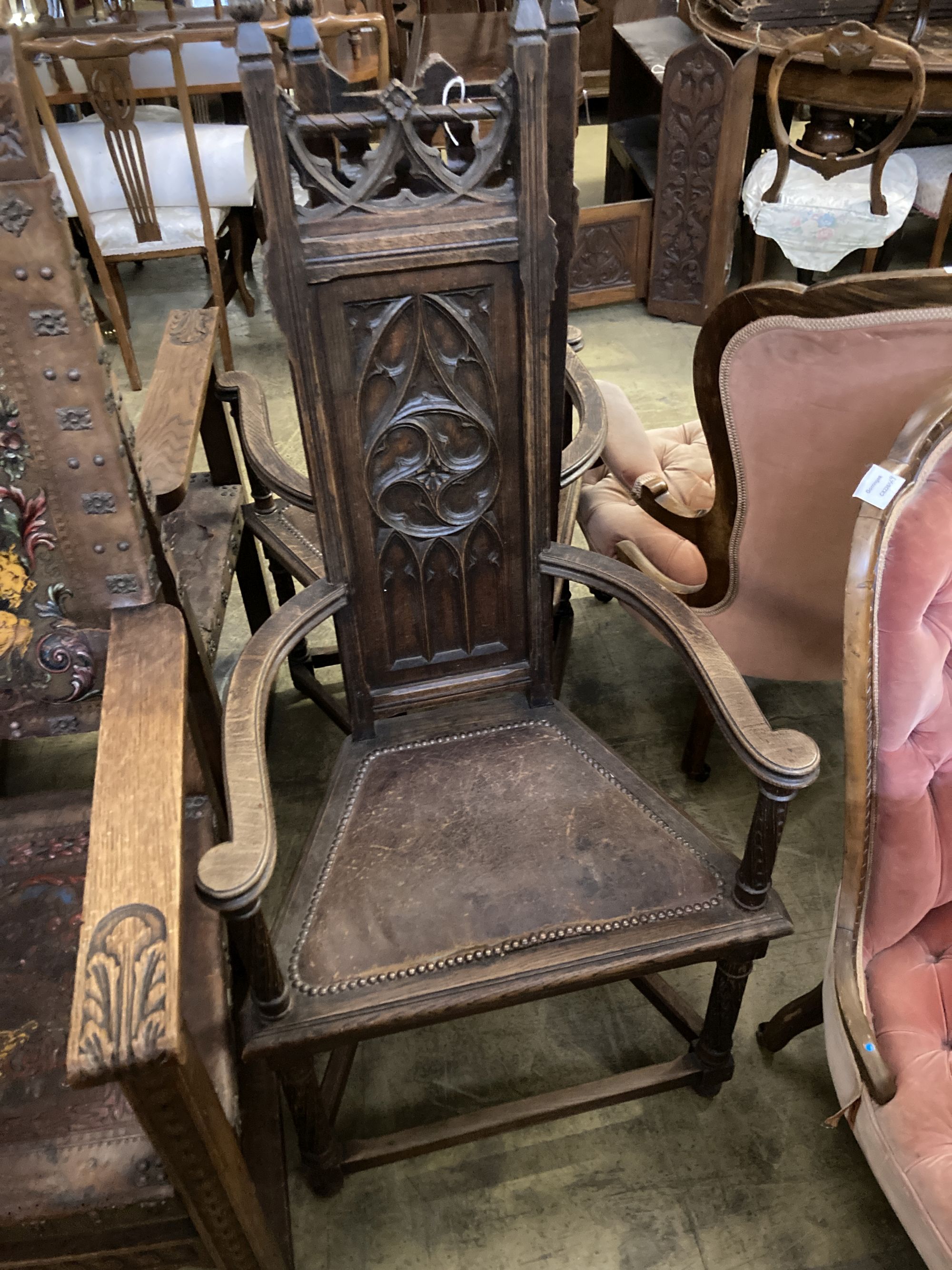 A pair of Gothic-style oak elbow chairs, width 59cm, depth 43cm, height 127cm